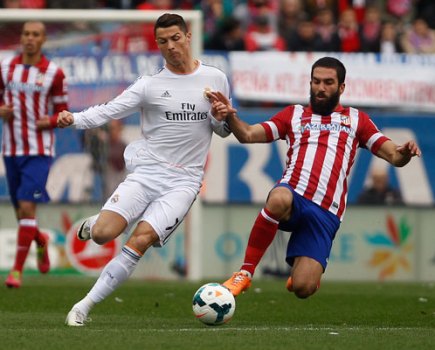 Real's Cristiano Ronaldo, left, in action with Atletico's Arda Turan
