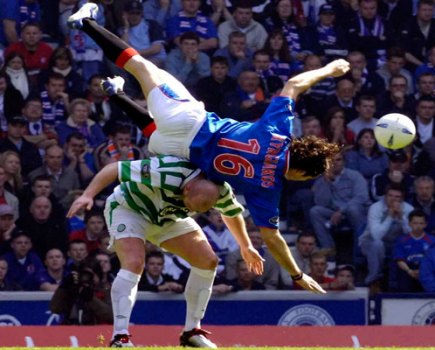 Rangers' Sotirios Kyrgiakos (top) tussles with Celtic's John Hartson