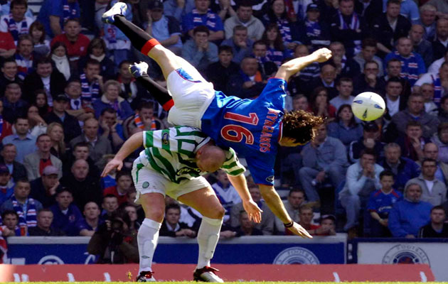 Rangers' Sotirios Kyrgiakos (top) tussles with Celtic's John Hartson