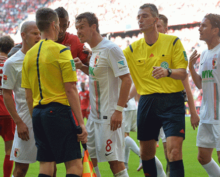 Augsburg argue with referee