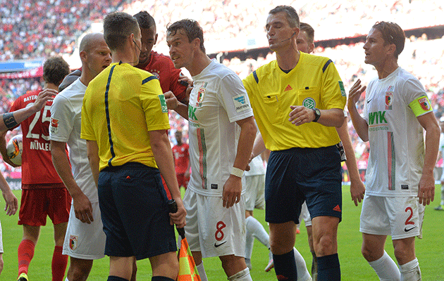 Augsburg argue with referee