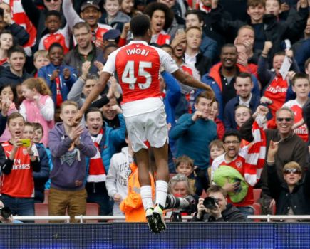 Wenger's record on promoting youth is poor. Alex Iwobi celebrates scoring against Watford